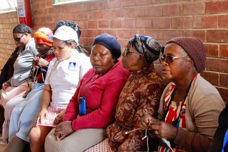 Photo of a group of people sitting in a passage