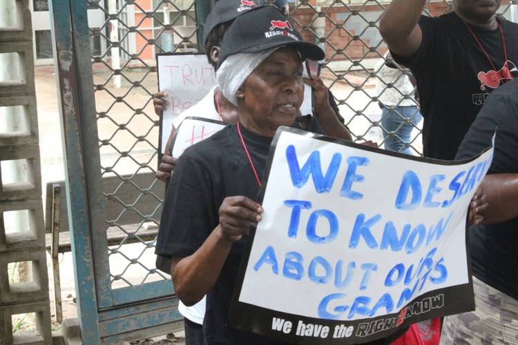 Photo of pensioner with placard