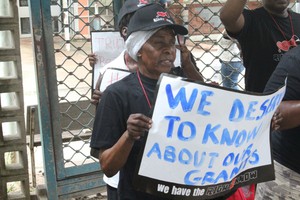 Photo of pensioner with placard