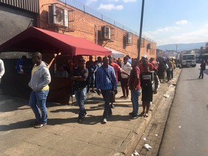 Photo of people along a street