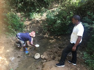 Photo of man and woman at stream