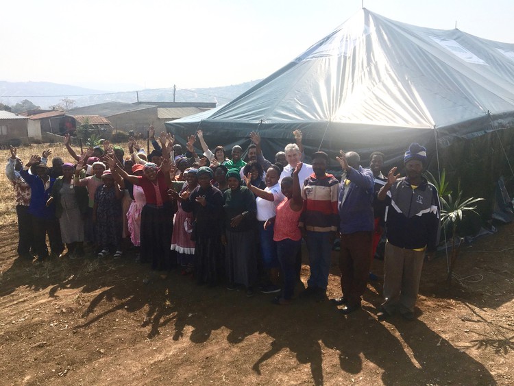 Photo of a tent with people