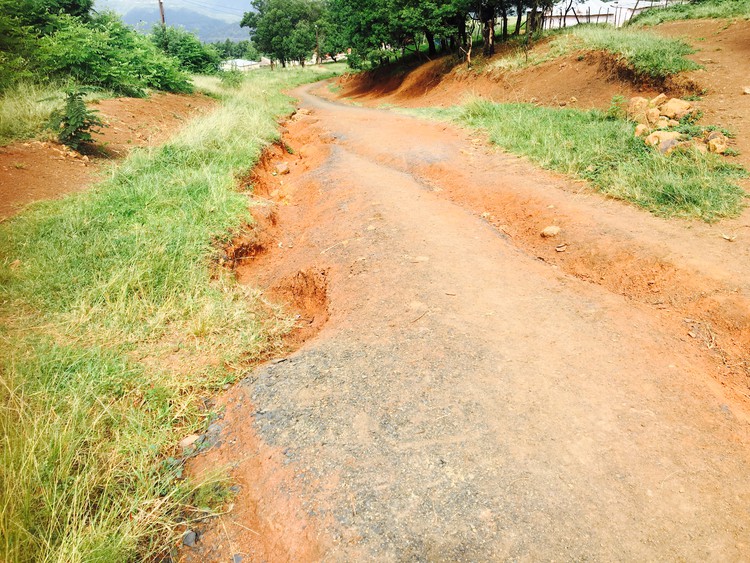 Photo of broken muddy road