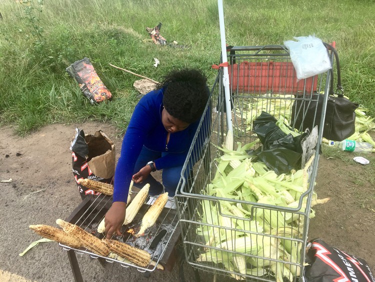 Photo of a woman cooking mielies