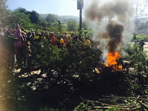 photo of burning tyres and branches in the road