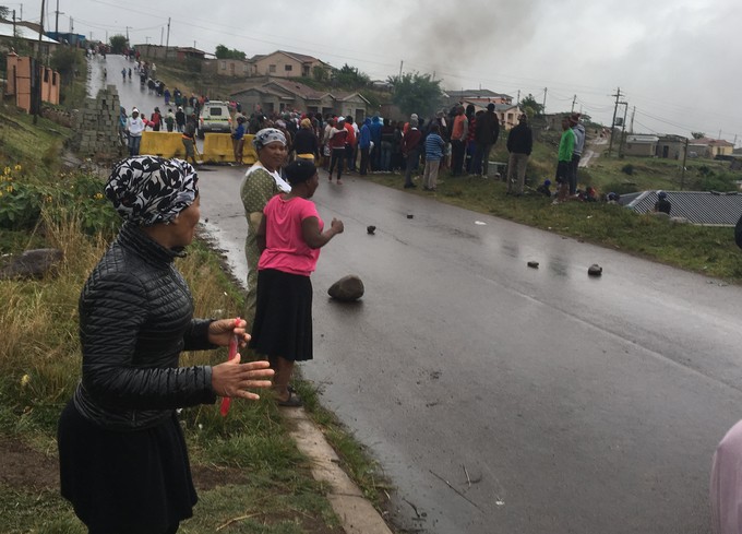 Photo of protest with barricade across road