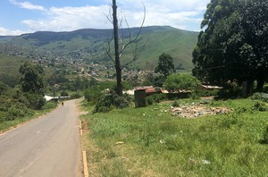 Photo of road and ruins of house