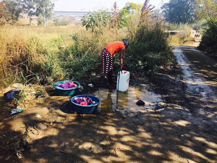 Photo of woman at tap