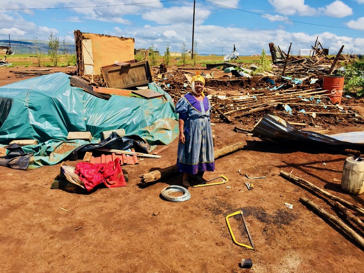 Photo of a woman standing in debris