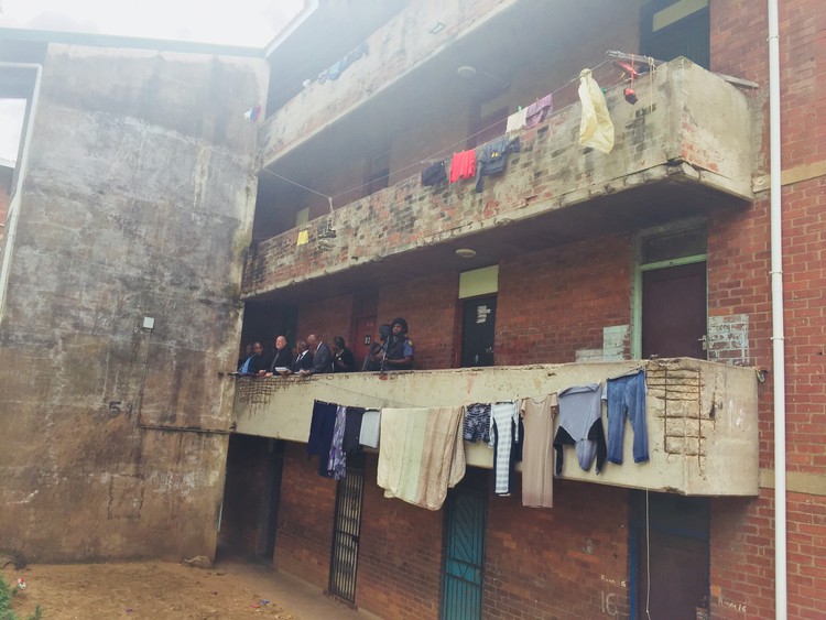 Photo of the court convoy standing in one of the hostel blocks