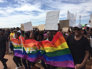 Photo of people marching with flag