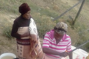 Photo of two women at a stream