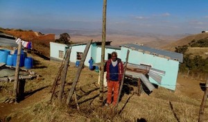 Photo of a man in a field next to a pole