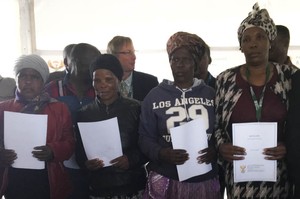 Photo of workers with share certificates