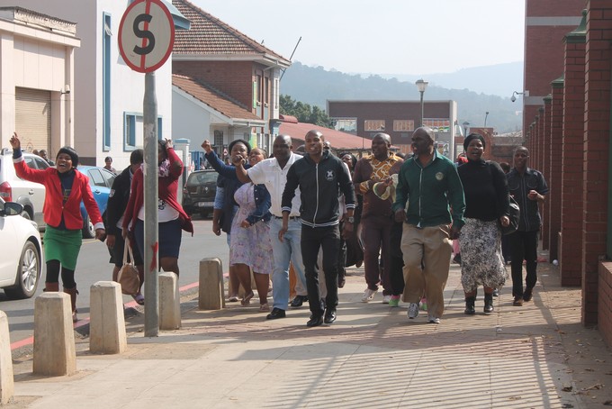 Photo of people marching in a celebratory style