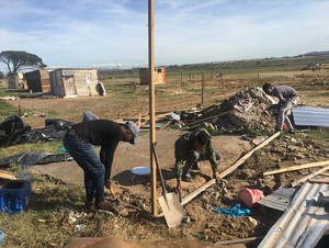 Photo of three boys building shack