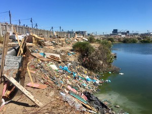 Photo of a dam and shacks