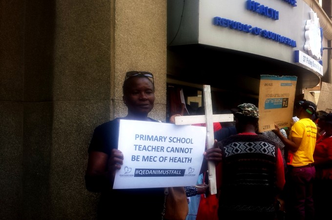 Photo of man holding a placard