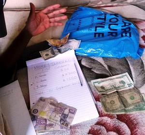 Photo of a book and money on a bed