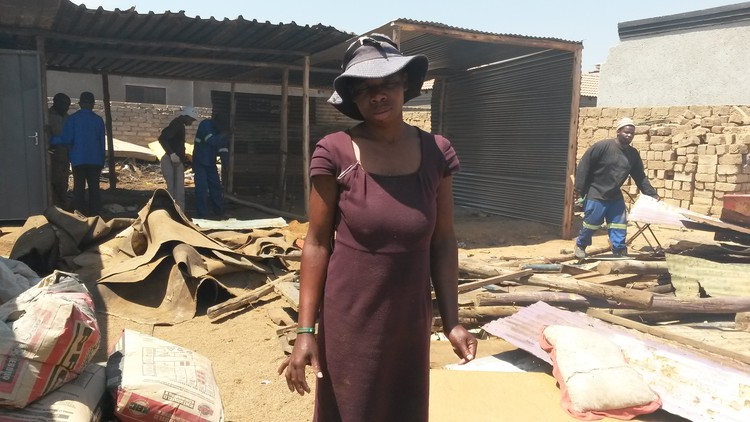 Photo of woman in front of shack