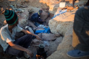 Photo of men in a mining trench