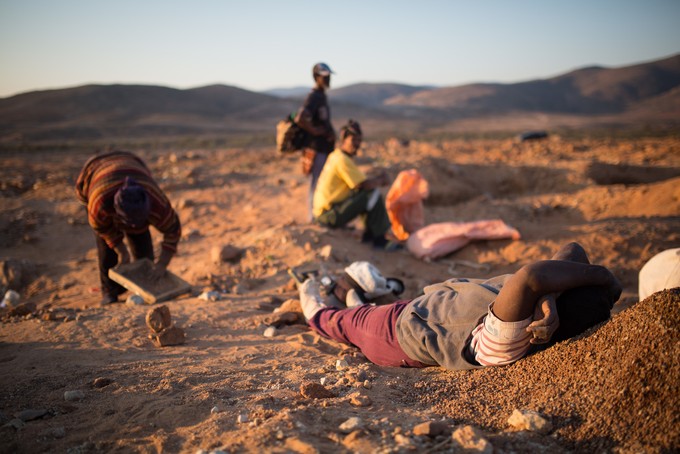 Photo of man sifting sand