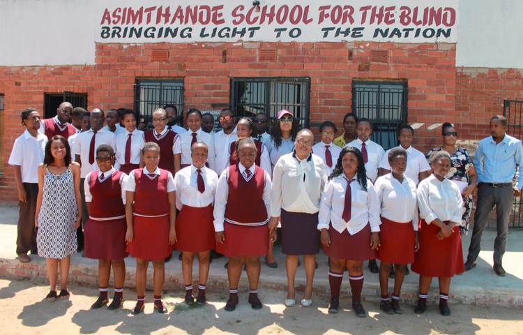 Photo of learners in front of a school