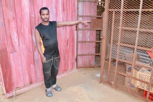 Photo of a man at his shop door