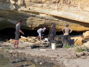 Photo of people digging coal