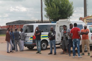 Photo of people standing outside police station