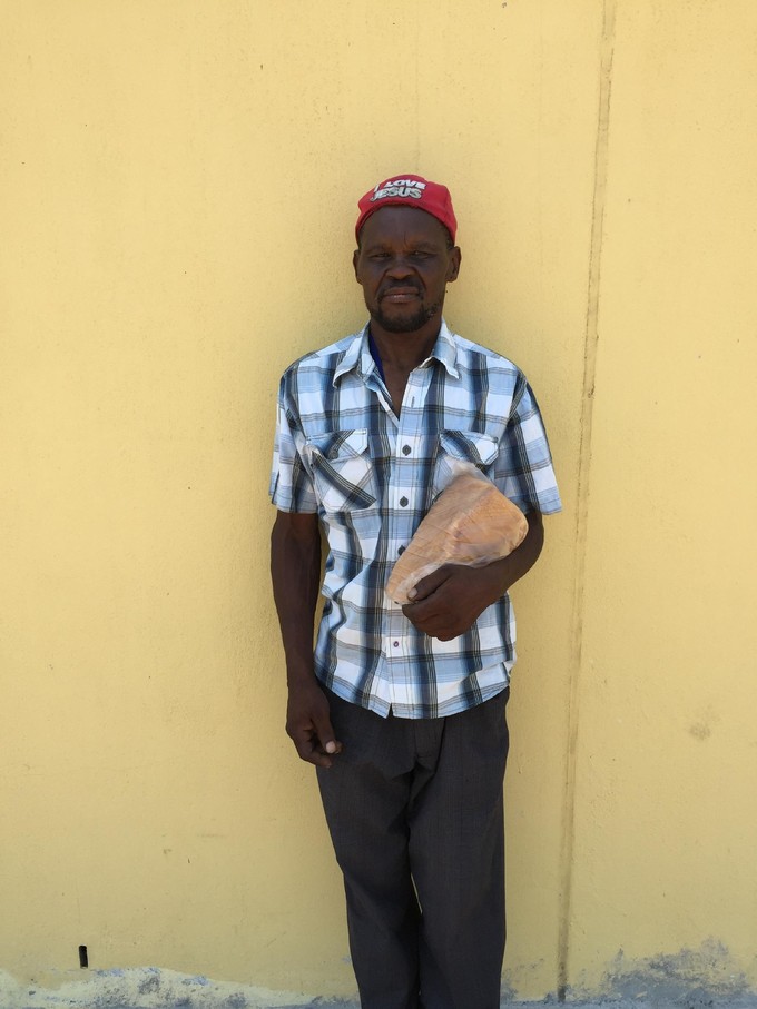 Picture of Matata Mbhele with a loaf of bread.