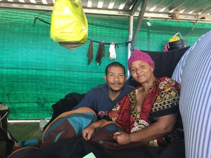 Photo of two people sitting next to one another