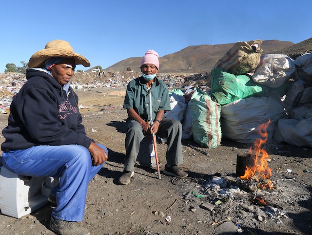 Photo of two people sitting at a fire