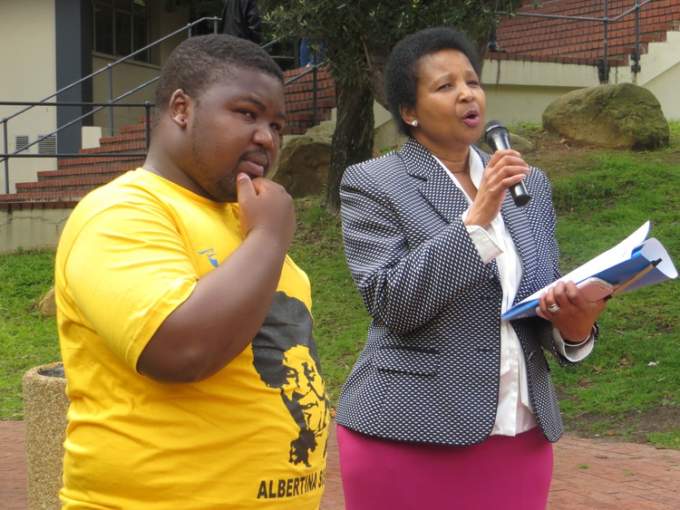 Photo of two people with microphones