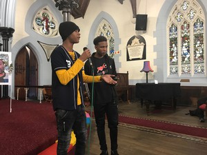 Photo of two boys addressing a meeting