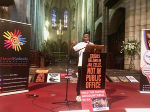 Photo of a man making a speech in a cathedral