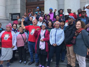 Photo of workers on the steps of the court