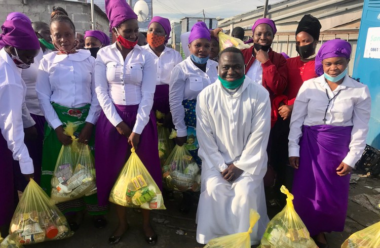 Photo of a group of people with bags of food