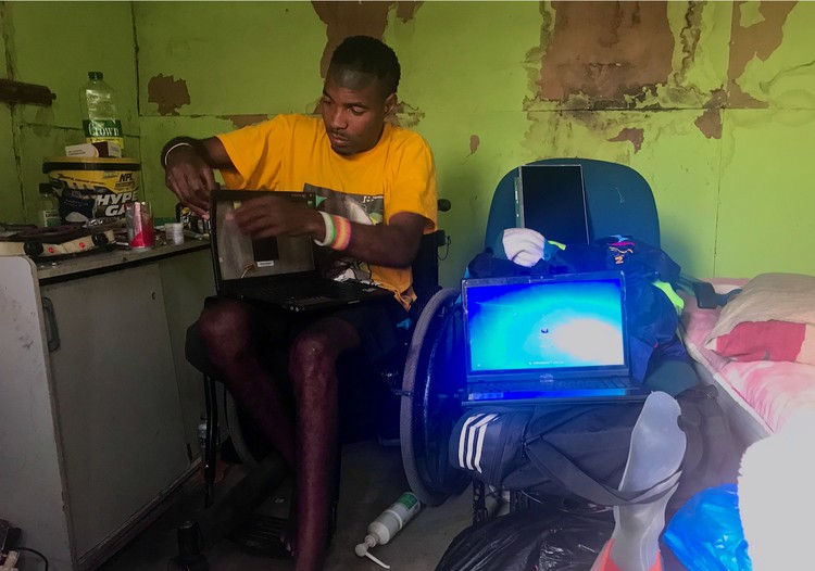 Photo of a man in a wheelchair working