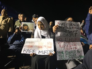 Photo of a girl holding a poster