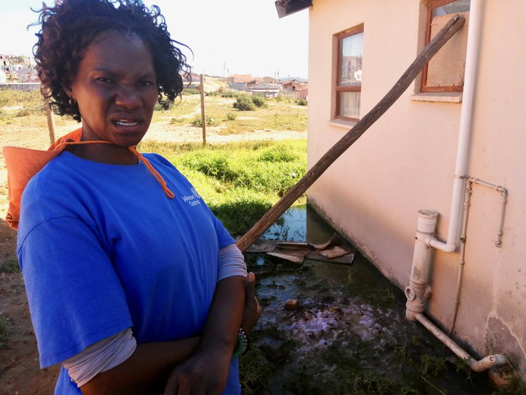 Photo of a woman outside her house