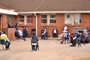 Photo of staff sitting in a yard