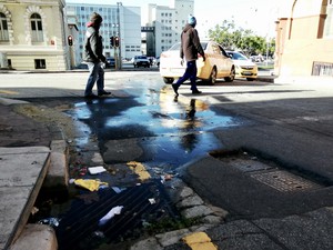 Photo of a street with water running down it