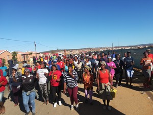 Photo of protestors marching down a street