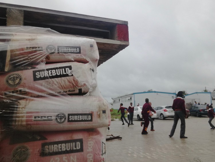 Children playing,  bags of cement