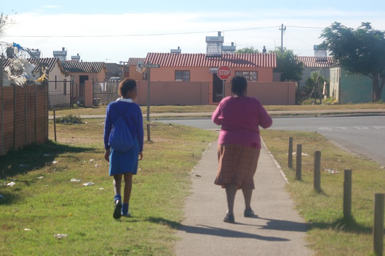 Photo of woman and child walking away