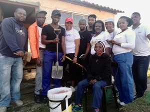 Photo of a group of people outside a house