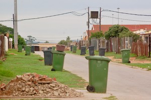 Photo of a street lined with wheeliebins