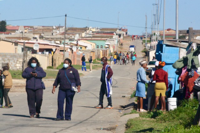 Photo of people walking in a street