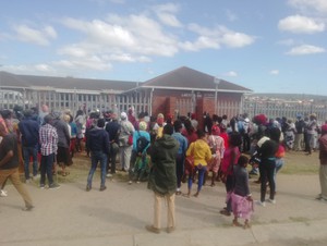 Photo of patients outside the clinic gates